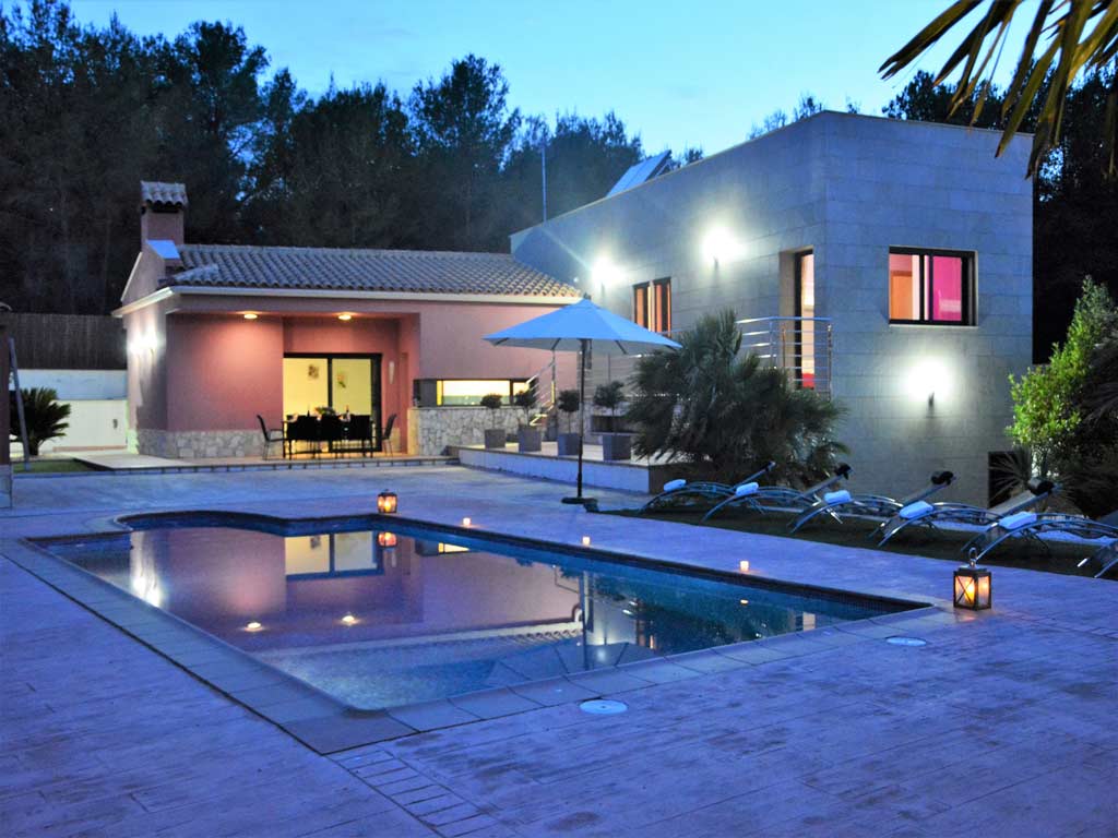 villa in Sitges at night with pool.